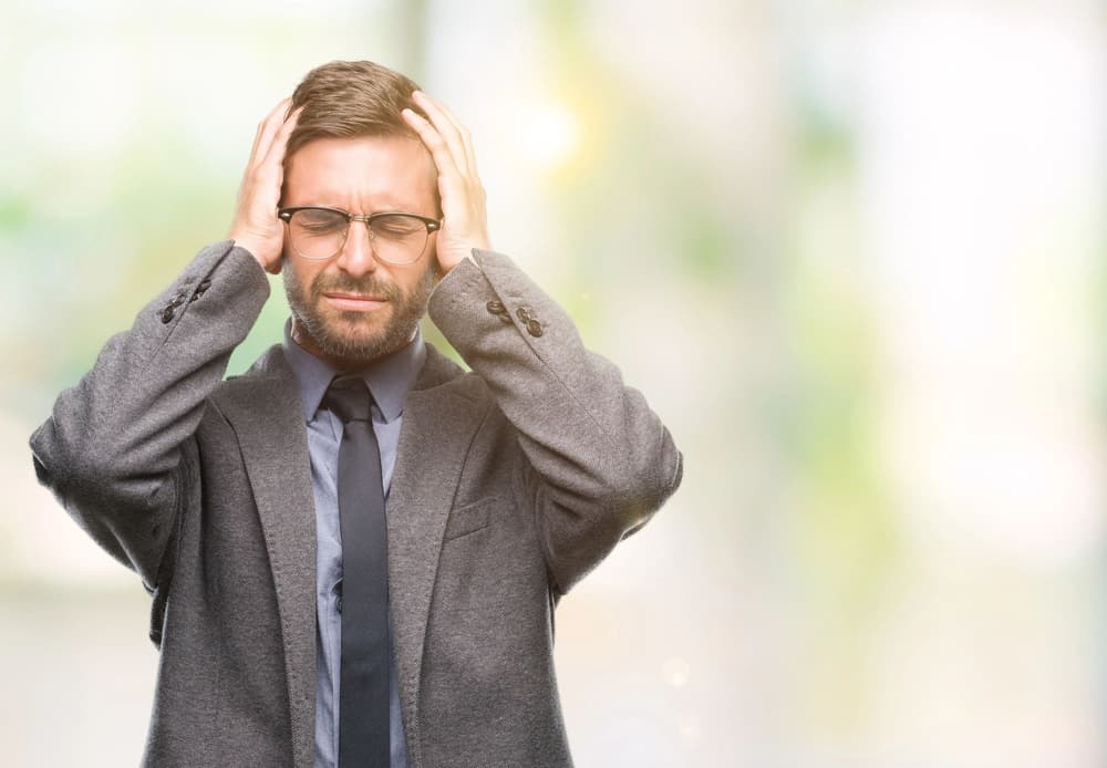 zmartwiony mężczyzna trzymający się za głowę zmartwiony mężczyzna trzymający się za głowę